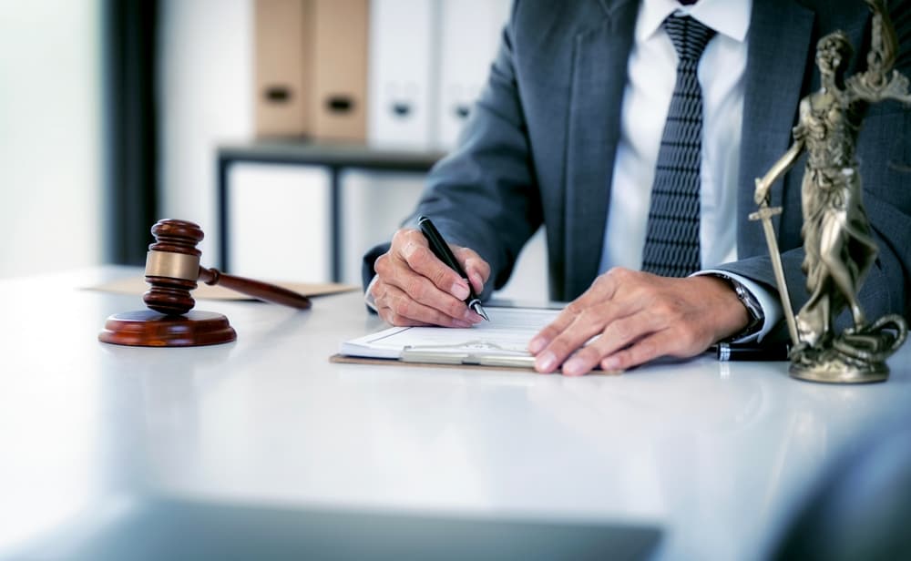 A lawyer who is also a businessman works in an office or courtroom, providing legal counsel with a gavel and knowledge of the law. This embodies the concept of justice and the role of a lawyer.