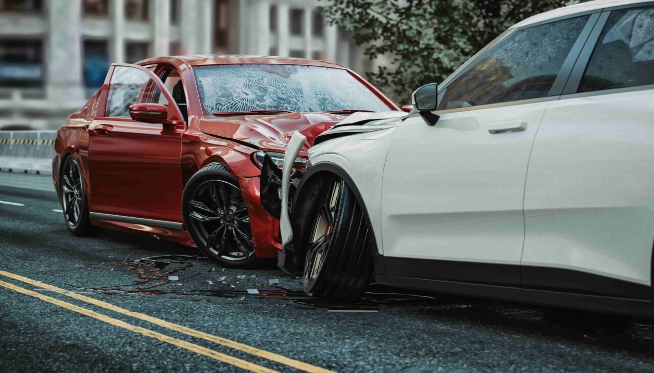 Head-on car accident between red and white vehicles on city street with severe front-end damage. Head-on car accident between red and white vehicles on city street with severe front-end damage.