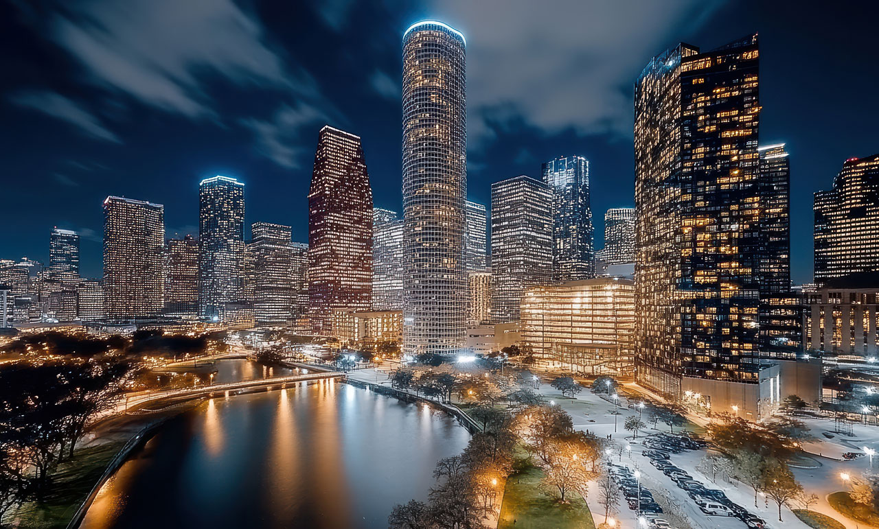 Downtown Houston skyline at night with city streets below, representing pedestrian safety and accident liability