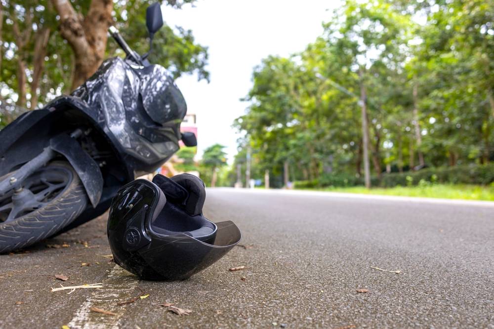 Motorcycle helmet on the road next to a crashed motorcycle in Texas