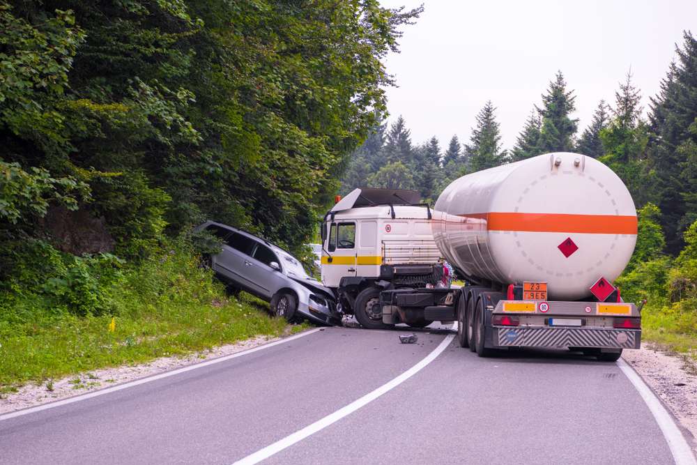 Car collision with a tanker truck on a rural road